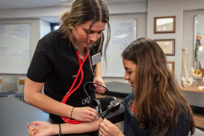 A master of athletic training student completing blood pressure.